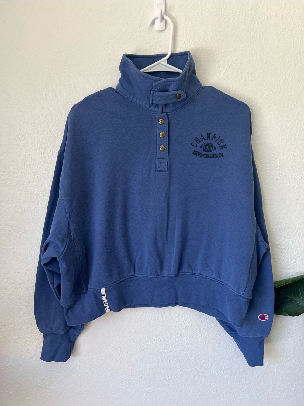 Women’s Champion Blue Cropped Henley Pullover with Chest Logo.